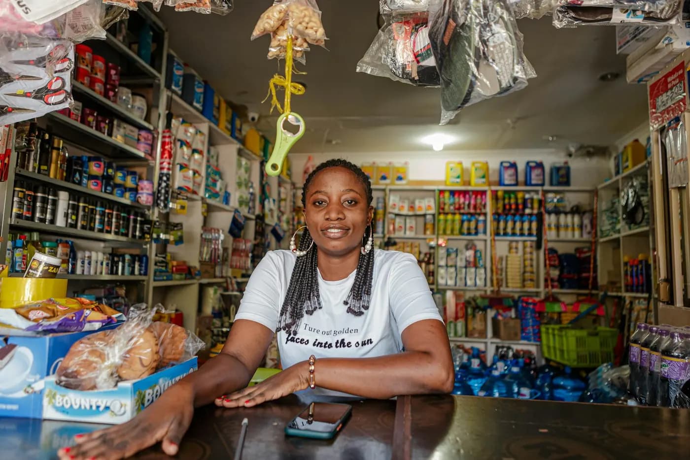 Agent standing behind the counter of her shop