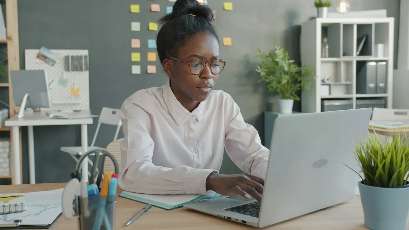 Finance officer running payroll on a laptop in her office