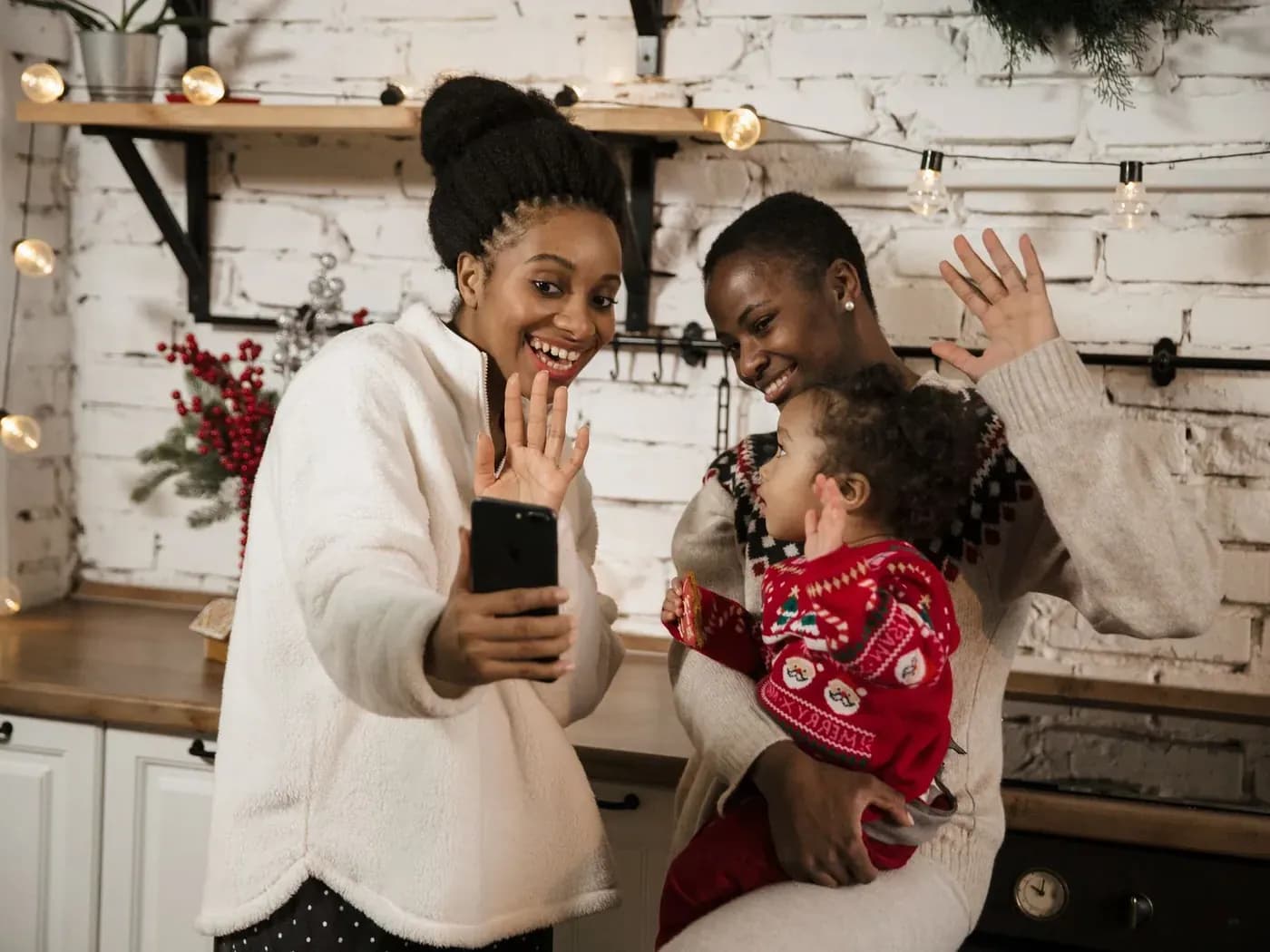 A family waving to a relative on a video call