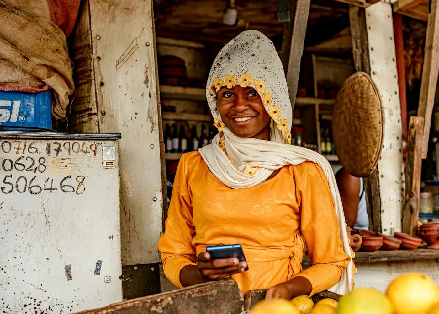 Market stall owner checking a payment on her phone