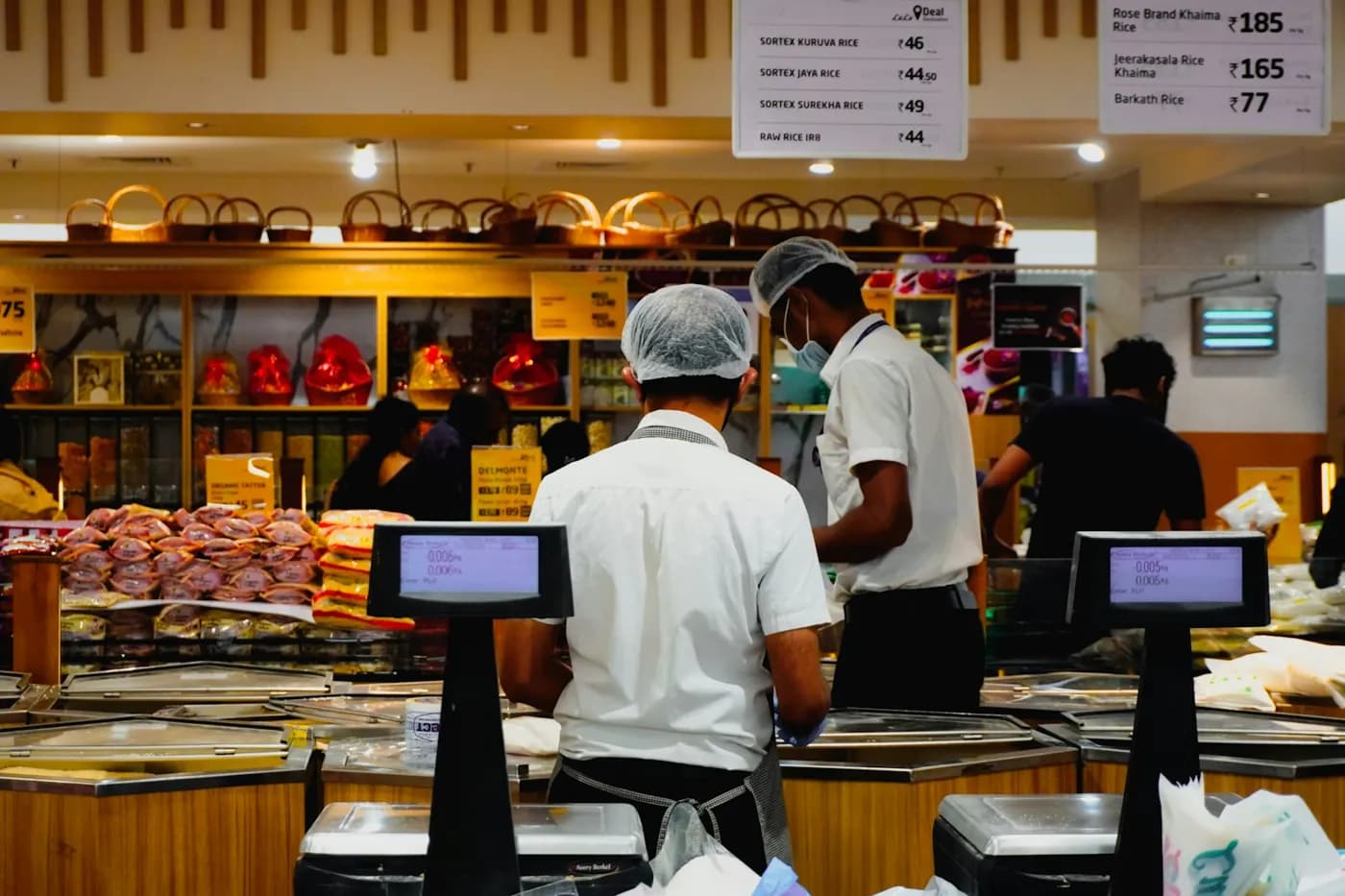 Supermarket checkout with cashiers at the tills