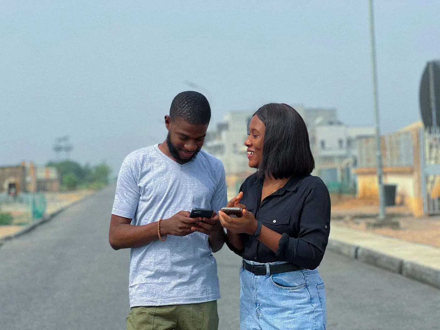 Two friends sending money phone to phone